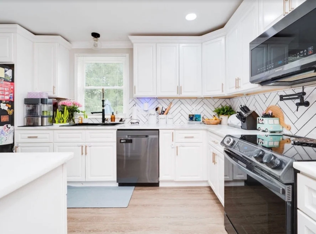 Bright white kitchen remodel with herringbone tile backsplash