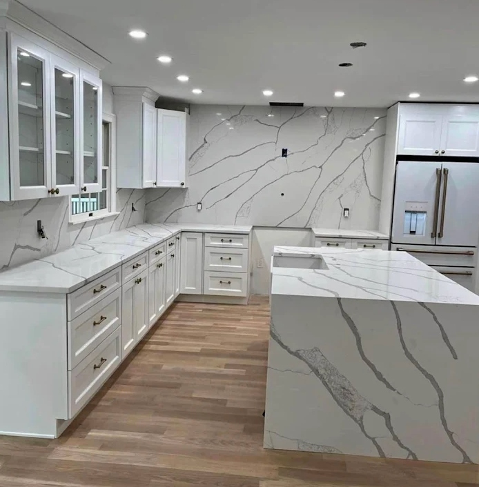Kitchen remodel with white cabinets and stone countertops